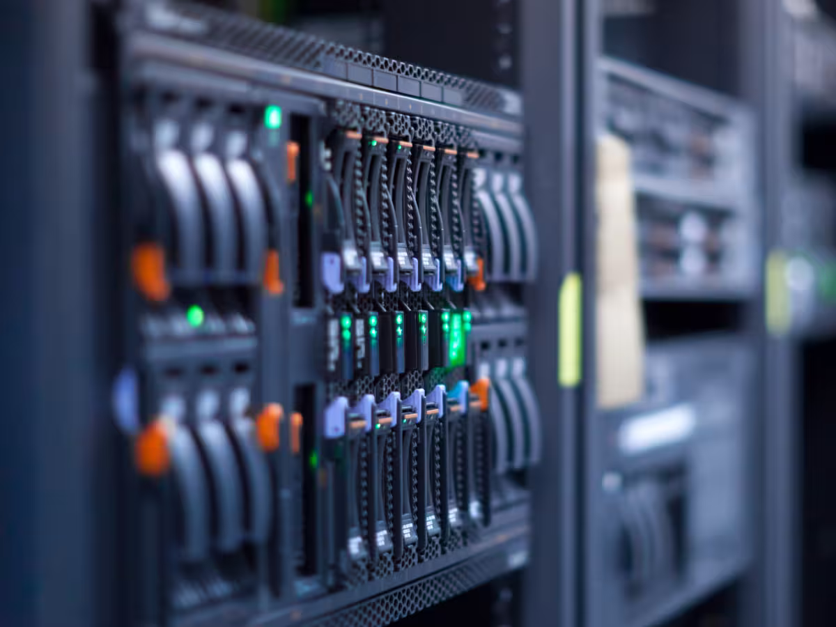 Close-up of a server rack with drive bays and status lights in a data centre environment.